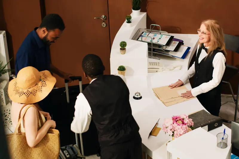 hotel front desk with guests checking in